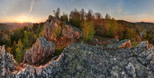 Mountain dramatic sunset panorama landscape, rock massif with green trees. Discovering tourism in the colorful landscape. photo