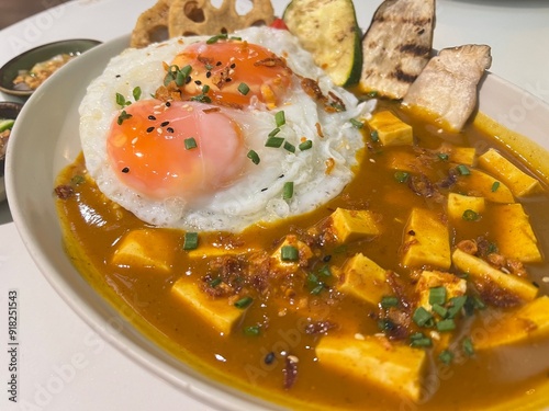 Tofu and Mushroom Curry sauce with fried vegetable and soft fried egg photo