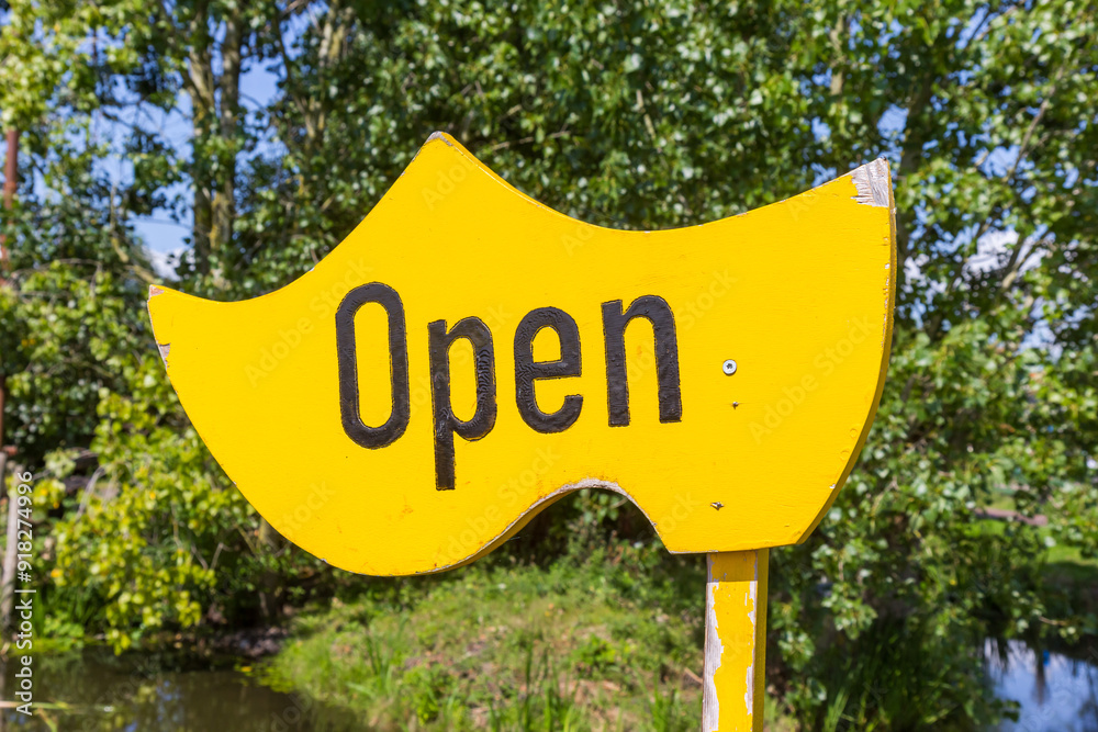 Open sign on a wooden yellow shoe in Marken, Netherlands