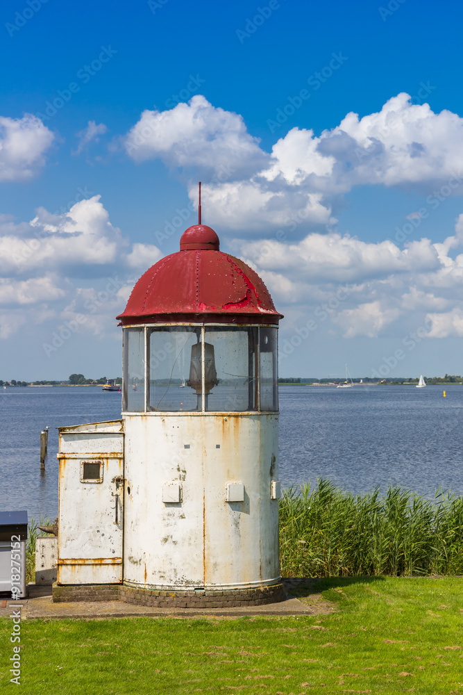 Little lighthouse on the shore of the IJsselmmer lake in Marken, Netherlands
