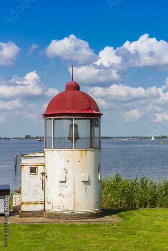 Obraz na płótnie Little lighthouse on the shore of the IJsselmmer lake in Marken, Netherlands w salonie