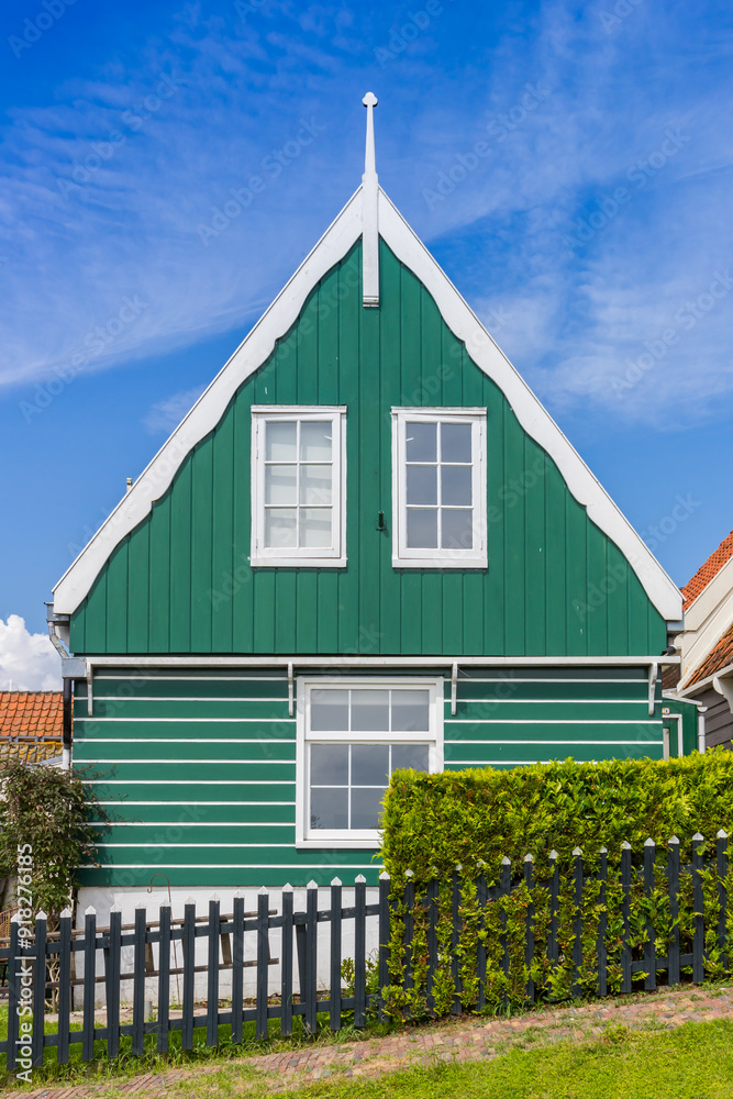 Front facade of a traditional green wooden house in Marken, Netherlands