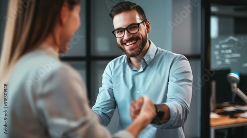 Interviewer and candidate smiling while shaking hands.