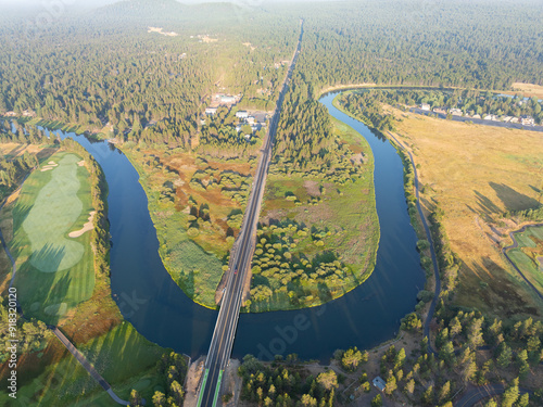 The beautiful Deschutes River winds through the rural landscape near Sunriver, Oregon. This area, in the foothills of the Cascade Mountains, is a popular vacation destination in the summer and winter. photo