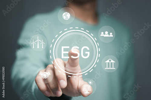 Businessman with ESG icon of saving clean energy environmental, social, governance, sustainable and corporation development, green eco friendly, environment, go green, CO2, ESG concept. photo