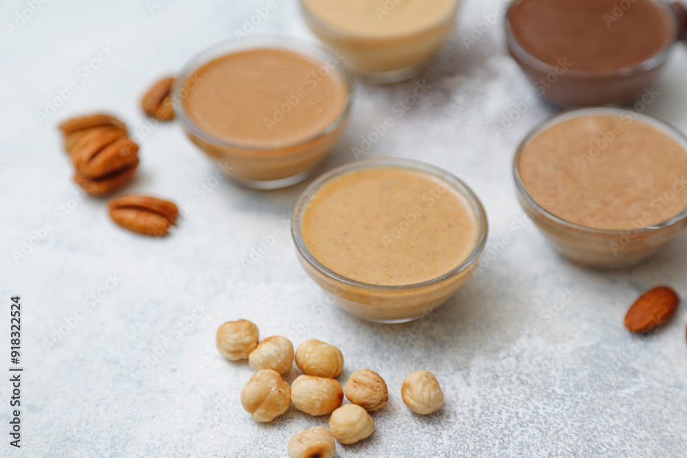 Homemade nuts butter in a glass jars with various nuts. Homemade nuts butter in a glass jars with various nuts.