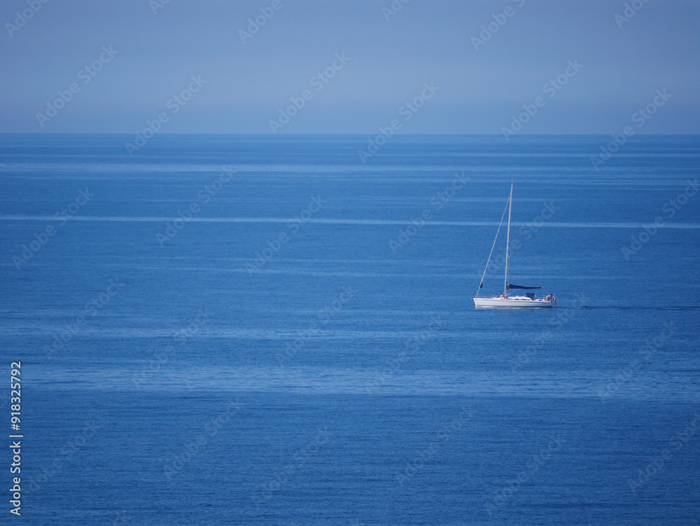 A sailboat yacht sails into the sea, aerial view A sailboat yacht sails into the sea, aerial view
