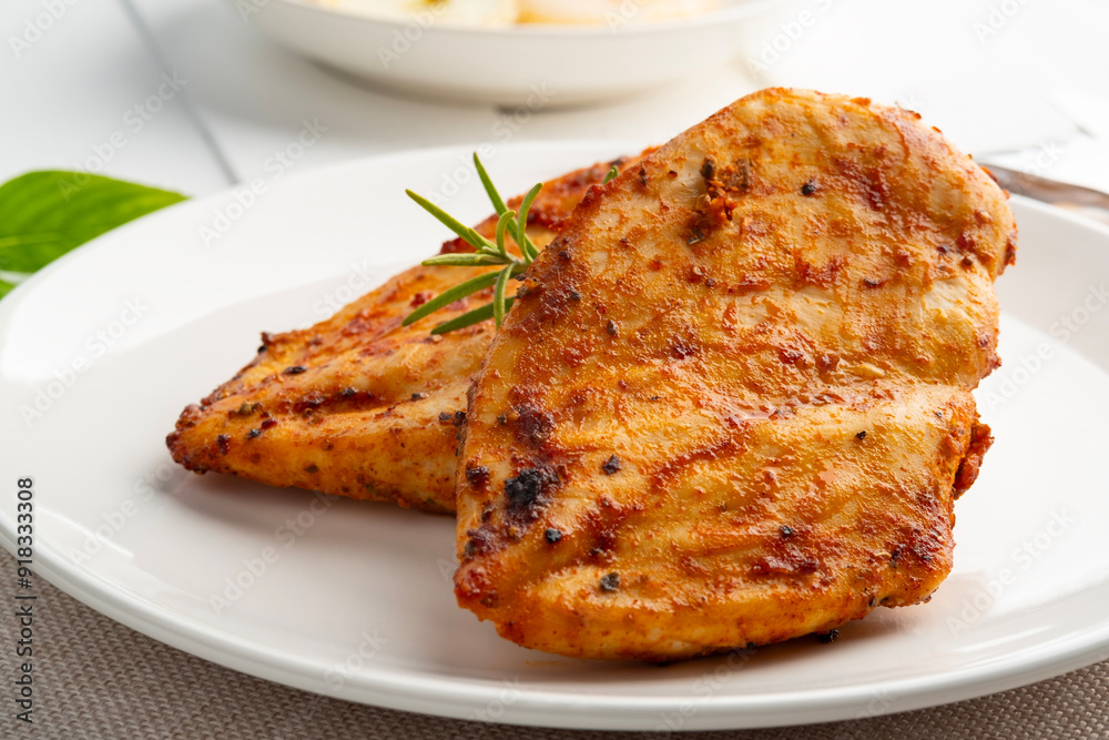 Air Fryer chicken breast seasoning with garlic,paprika,salt and pepper in a plate.Healthy oilless cooking.Diet menu. Air Fryer chicken breast seasoning with garlic,paprika,salt and pepper in a plate.Healthy oilless cooking.Diet menu.