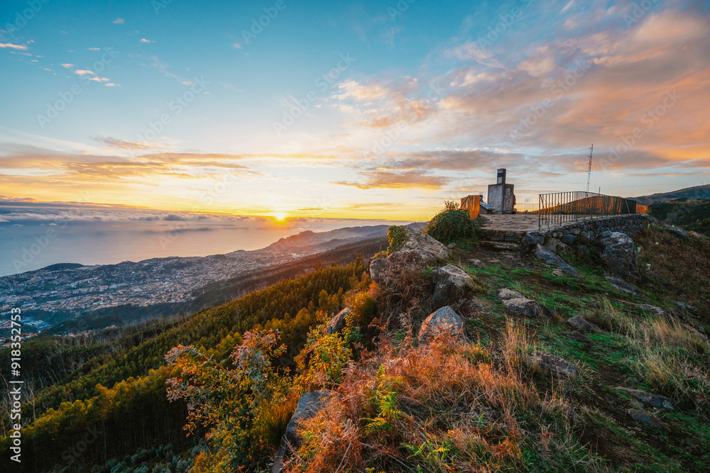 beautiful sunset over the city of Funchal on Madeira from the location Miradouro do Pico Alto. Mountains landscape beautiful sunset over the city of Funchal on Madeira from the location Miradouro do Pico Alto. Mountains landscape