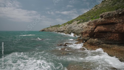 Province of Castellon. Favorite place for active walks. Mediterranean coast on a sunny day in spring. Sun glare on azure sea water. VIA VERDE BENICASIM OROPESA. Spain