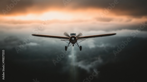 A vintage single-engine airplane captures the essence of adventure and exploration as it navigates through dramatic clouds during a scenic sunset flight. photo