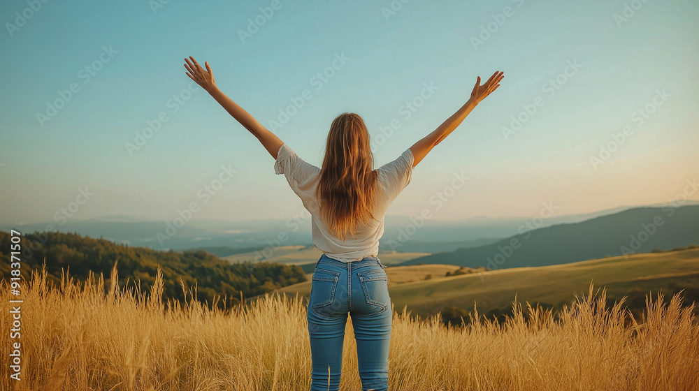 Woman standing in a field with arms raised towards the sky, symbolizing freedom and happiness, with a vast landscape and golden sunlight in the background. Woman standing in a field with arms raised towards the sky, symbolizing freedom and happiness, with a vast landscape and golden sunlight in the background.
