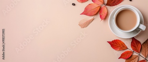 Warm Cup of Tea Surrounded by Autumn Leaves and Berries on a Soft Background