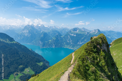 The Stoos hike in summer offers breathtaking views of the Swiss Alps, lush green meadows, and serene lakes. The trail is accessible yet challenging, with panoramic vistas that make every step rewardin