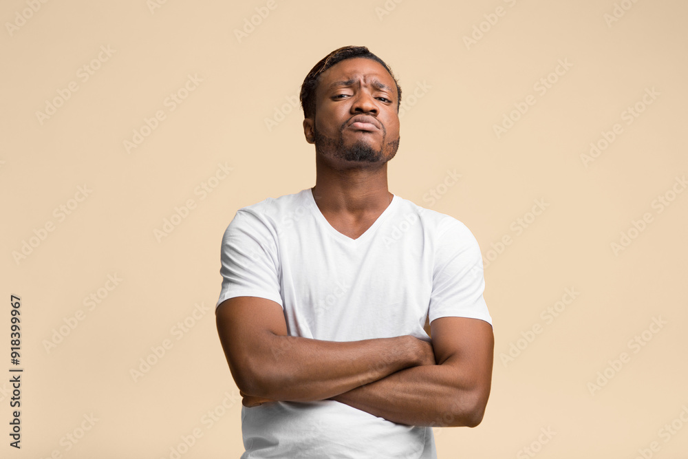 Serious Afro Man Standing Crossing Hands Looking At Camera Over Yellow Background. Studio Shot Serious Afro Man Standing Crossing Hands Looking At Camera Over Yellow Background. Studio Shot