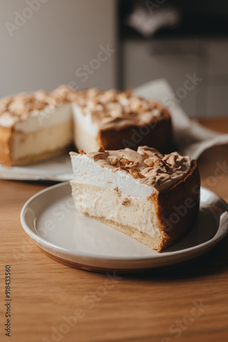 Wallpaper Mural A slice of delicious homemade baked cheesecake with creamy meringue texture dessert decorated with walnuts on top filled with tasty flavors and caramel drops on craft bakery paper standing on a wooden Torontodigital.ca