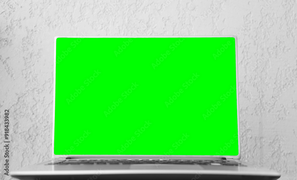 front view of silver Laptop with green mockup monitor isolated on white wall background. mock-up template. notebook with keyboard blank screen isolated with clipping path on white backdrop. front view of silver Laptop with green mockup monitor isolated on white wall background. mock-up template. notebook with keyboard blank screen isolated with clipping path on white backdrop.