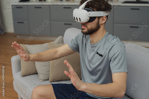 Beautiful young man in sports clothing exercising at home