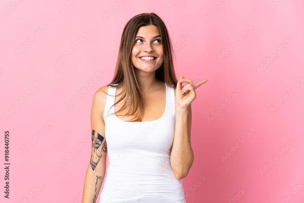 Young slovak woman isolated on pink background intending to realizes the solution while lifting a finger up Young slovak woman isolated on pink background intending to realizes the solution while lifting a finger up