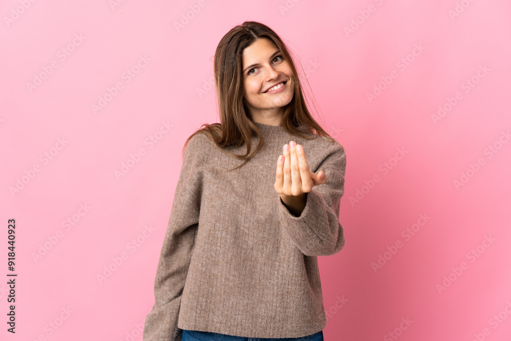 Young slovak woman isolated on pink background inviting to come with hand. Happy that you came Young slovak woman isolated on pink background inviting to come with hand. Happy that you came