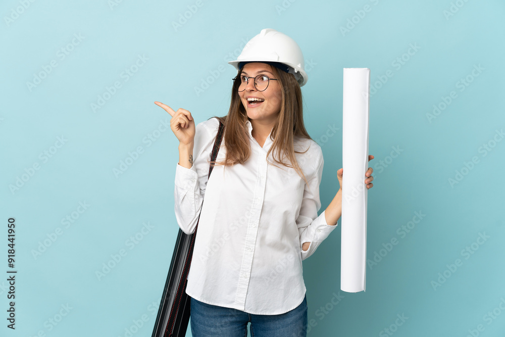 Slovak architect girl holding blueprints isolated on blue background intending to realizes the solution while lifting a finger up