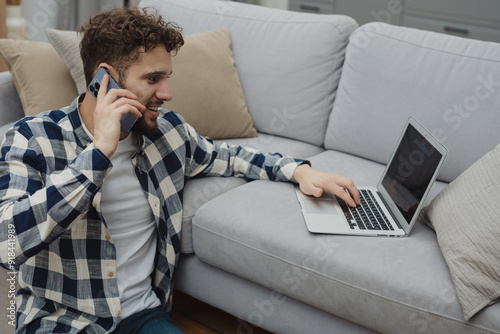 High angle view of an young brunette working at her office desk with documents and laptop.