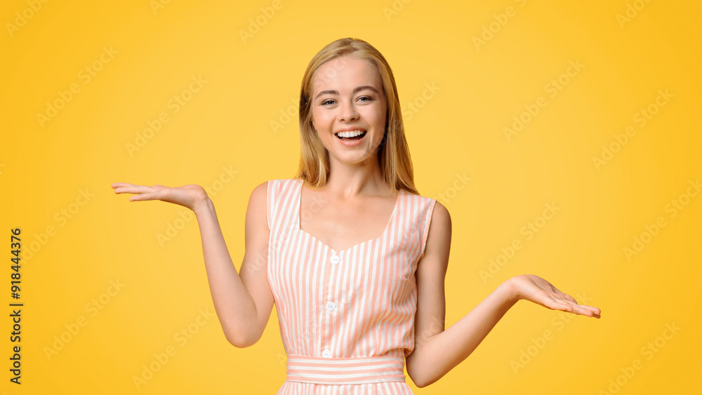 Joyful young girl in summer dress demonstrating something on her empty palms, comparing options, making scales of her hands over yellow background Joyful young girl in summer dress demonstrating something on her empty palms, comparing options, making scales of her hands over yellow background