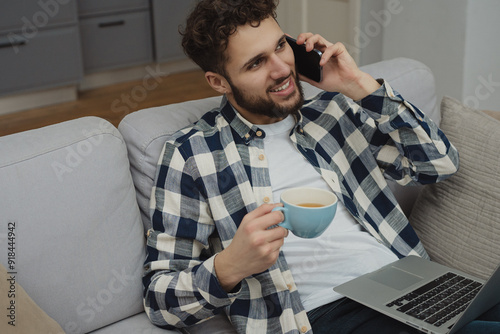 High angle view of an young brunette working at her office desk with documents and laptop.