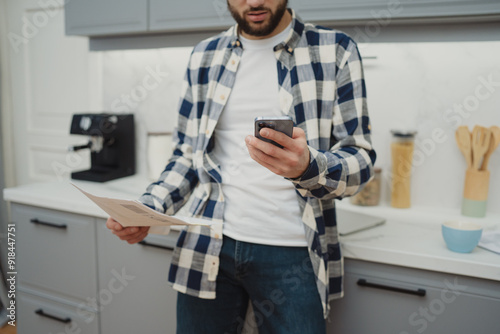 High angle view of an young brunette working at her office desk with documents and laptop.