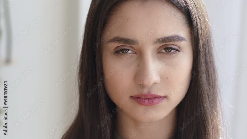 Portrait of serious confident young woman, looking at camera at home Portrait of serious confident young woman, looking at camera at home