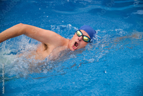 Professional athlete swimming front crawl during training in a swimming pool photo