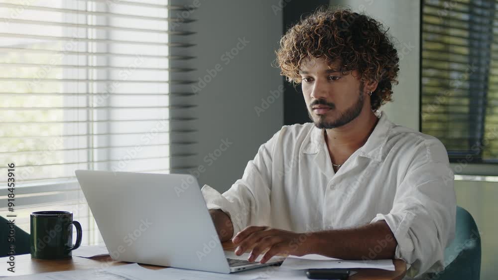 Busy businessman works on a laptop while sitting at workplace in business home office. 