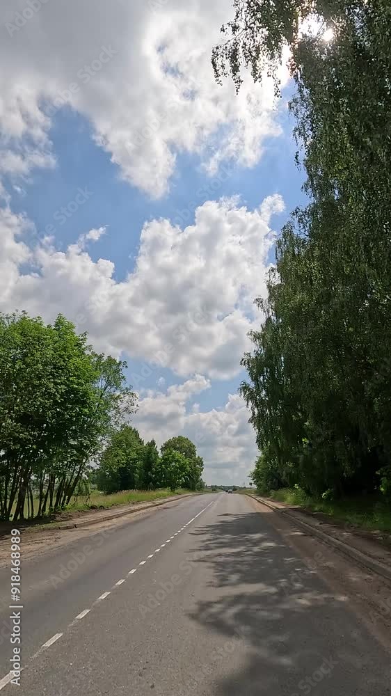 The car drives along the road on a summer day. Highways, roadside and road line markings. The car drives along the road on a summer day. Highways, roadside and road line markings.