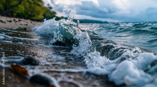  A tight shot of a wave colliding with the sandy shore, surrounded by trees and a expansive body of water behind