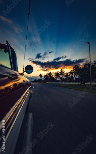Vertical photo of moving car with beautiful sunset view