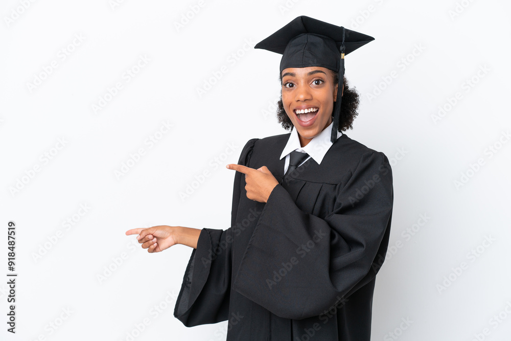 Young university graduate African American woman isolated on white background surprised and pointing side Young university graduate African American woman isolated on white background surprised and pointing side