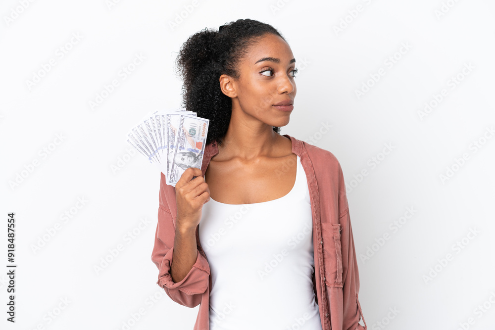 Young African American woman taking a lot of money isolated on white background looking to the side Young African American woman taking a lot of money isolated on white background looking to the side