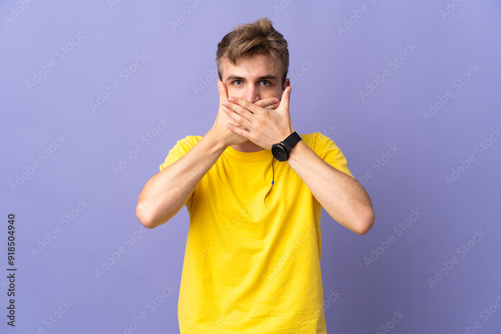 Young handsome blonde man isolated on purple background covering mouth with hands Young handsome blonde man isolated on purple background covering mouth with hands