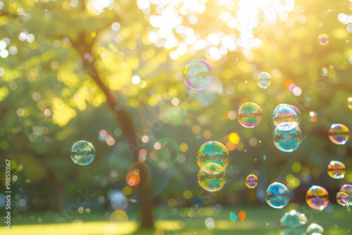 Rainbow soap bubbles on blurred green background photo