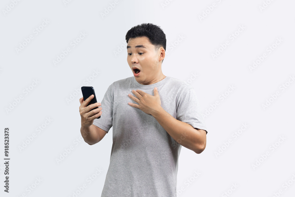 Portrait of excited man looking smartphone and hand on his chest isolated on white background Portrait of excited man looking smartphone and hand on his chest isolated on white background