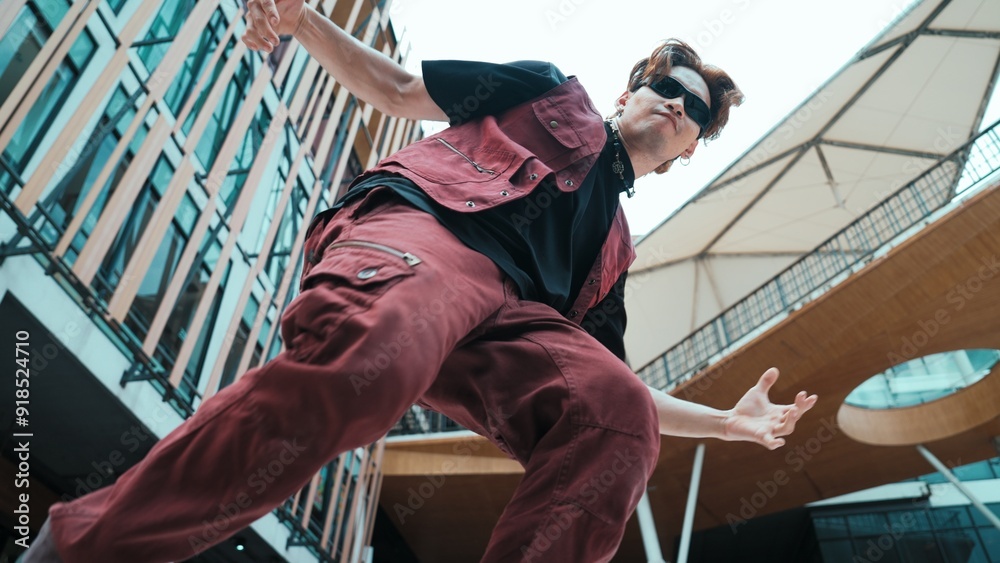 Low angle of asian attractive hipster pose at camera surround by mall. Portrait of break dance choreographer looking at camera while dancing in hip hop style. Outdoor sport 2024. Hiphop. Low angle of asian attractive hipster pose at camera surround by mall. Portrait of break dance choreographer looking at camera while dancing in hip hop style. Outdoor sport 2024. Hiphop.