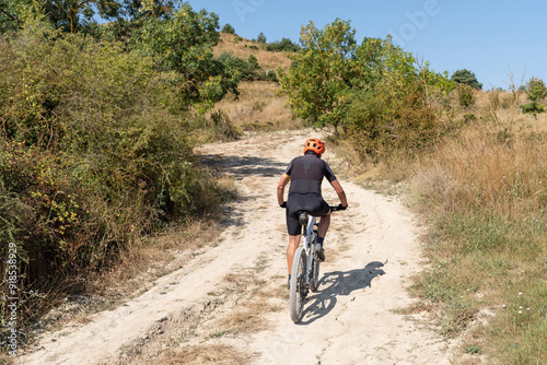 Cyclist with mountain bike on forest track