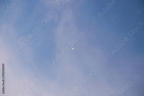 A photo of the moon during the day amidst the sky