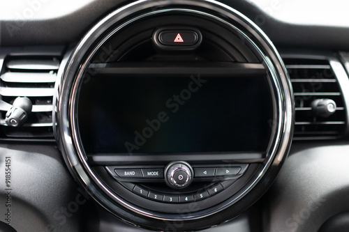 The round car dashboard features a display with various controls and functions to help the driver navigate and manage the vehicle