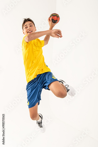 One happy handball player, teenager boy in studio isolated on white background. Hobby and healthy lifestyle