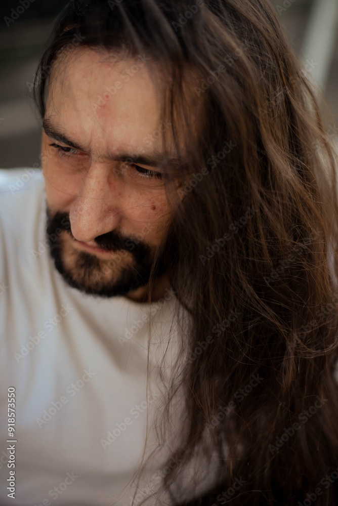 guy with long hair poses for the camera guy with long hair poses for the camera