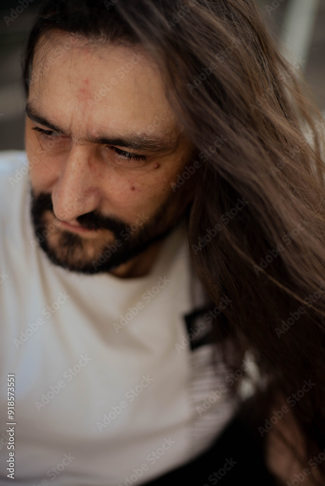 guy with long hair poses for the camera guy with long hair poses for the camera