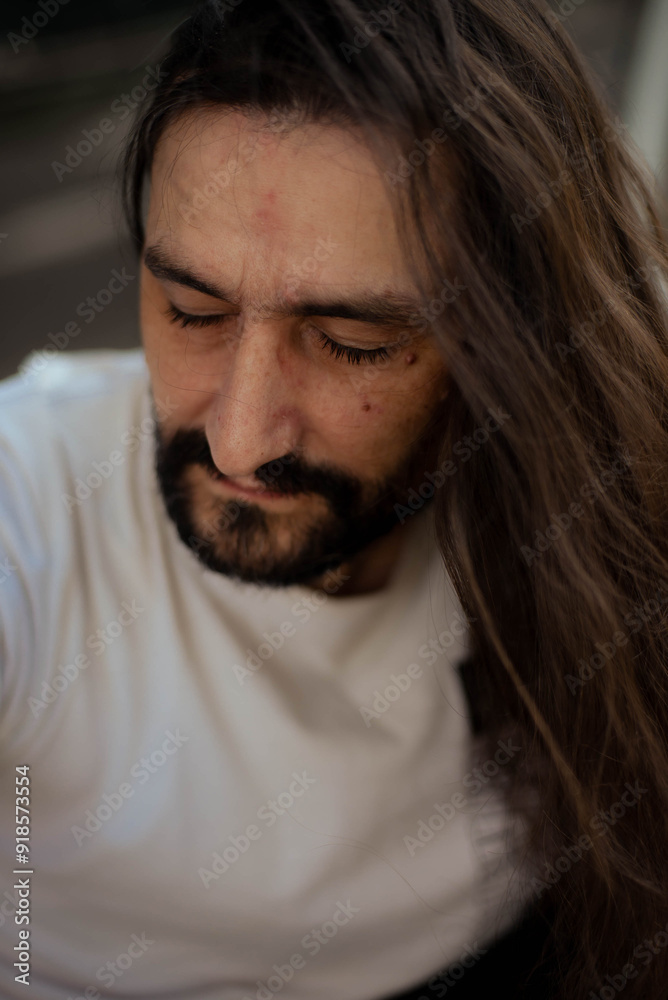 guy with long hair poses for the camera guy with long hair poses for the camera