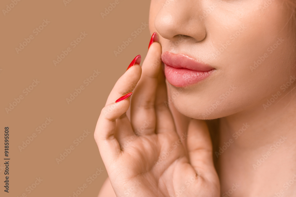 Obraz premium Young woman with beautiful lips on brown background, closeup