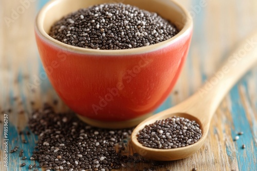 Close-up of Chia Seeds in Red Bowl with Wooden Spoon on Rustic Wooden Table